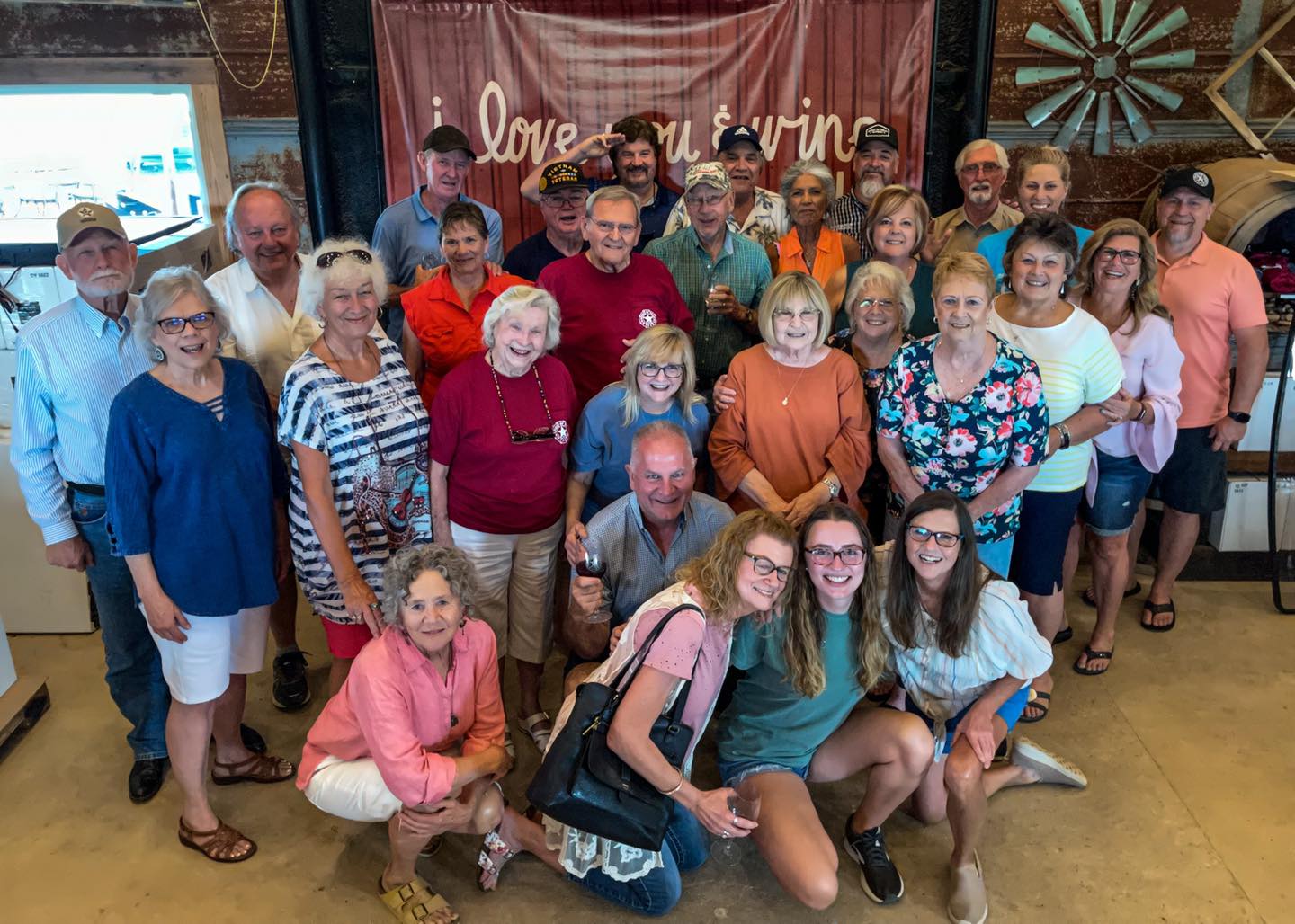 Image of a Group of People Smiling at a Winery Business