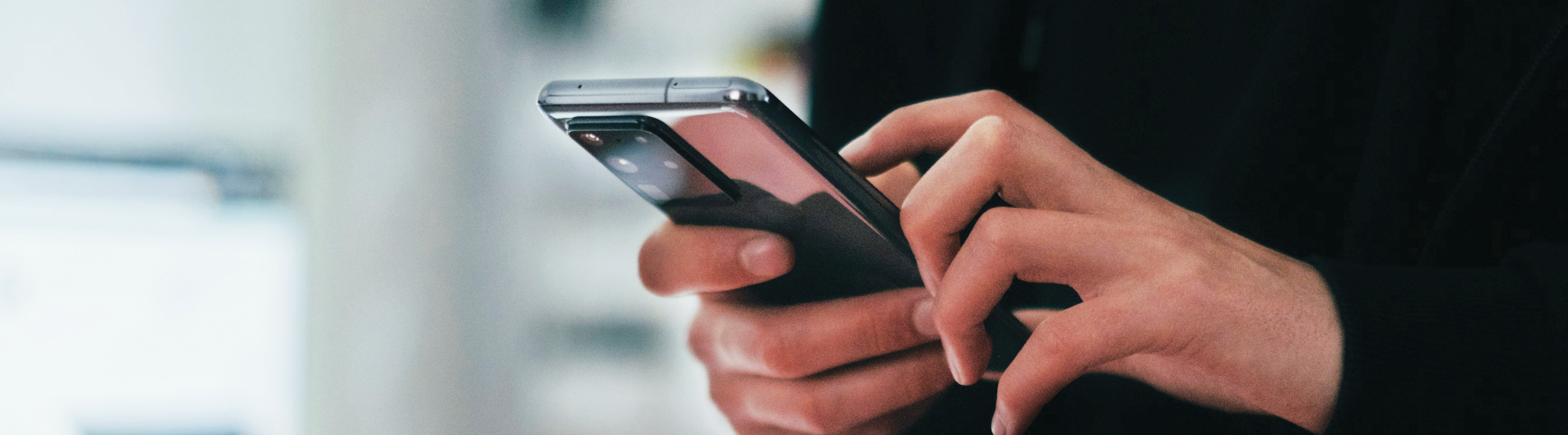 Image of a Person on their Phone Banner