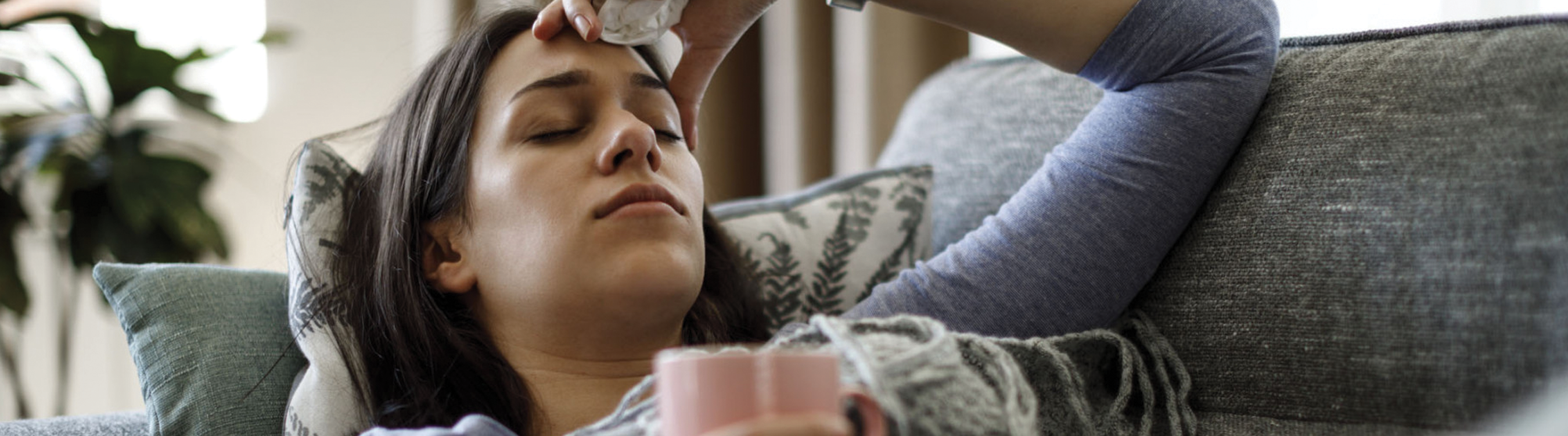 Image of an Ill Woman on a Couch Banner