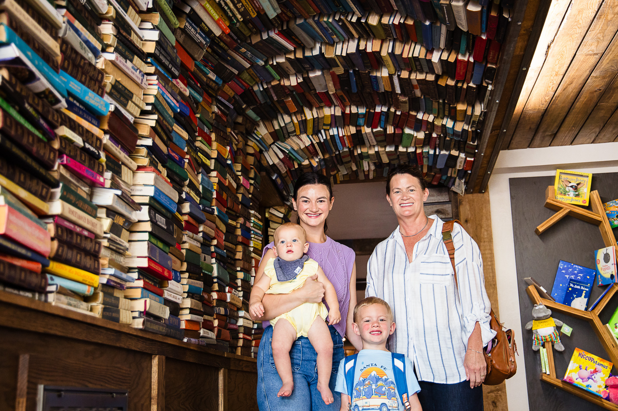Picture of a family of 4 in front of a book tunnel